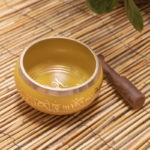 yellow metal singing bowl